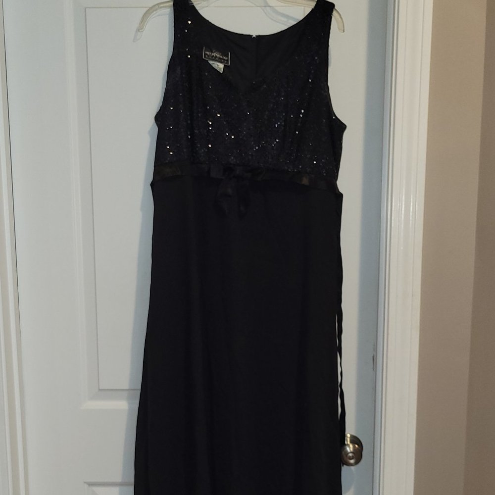 Sleeveless black high waisted dress with sequined top and sash with bow.